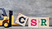 CSR Bauklötze Drei Bauklötze auf denen die Buchstaben C, S, R zu sehen sind.