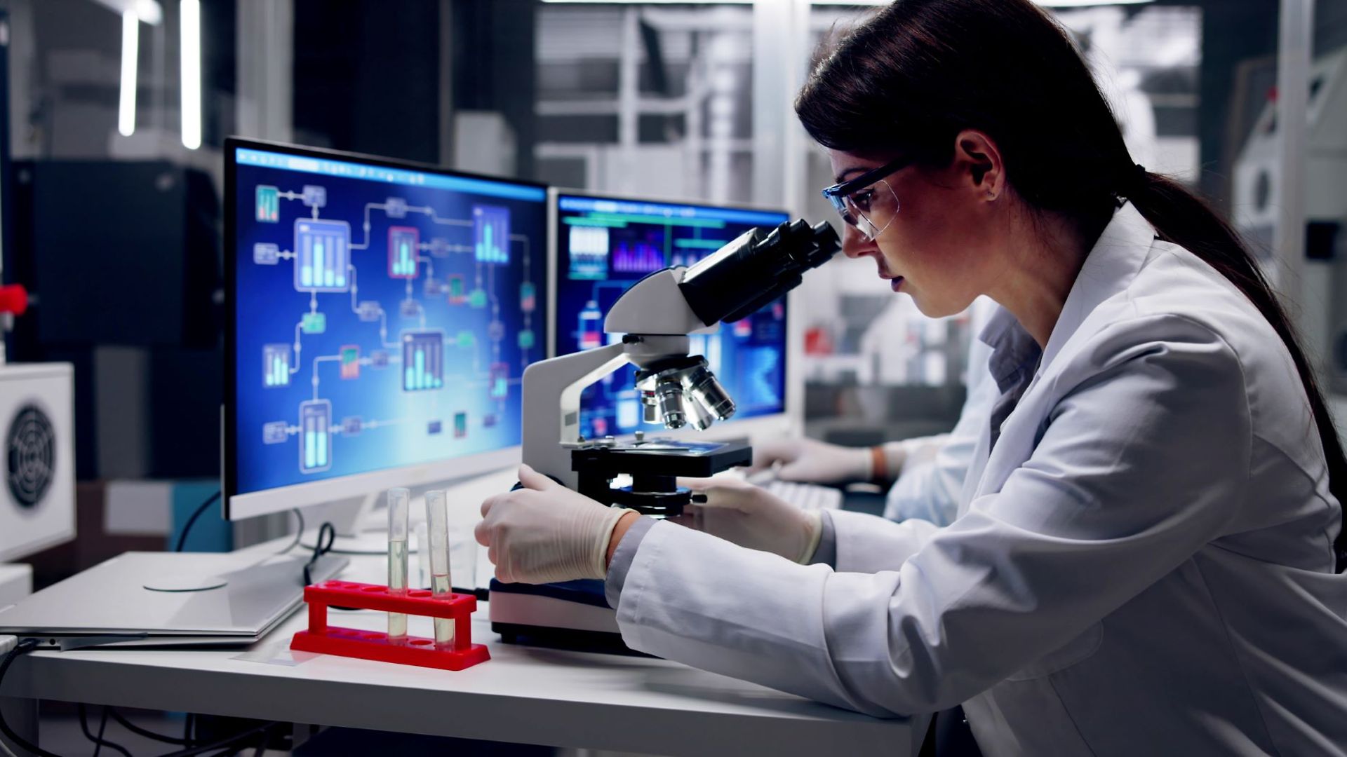 Wissenschaftlerin blickt in ein Mikroskop