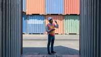 Worker in front of some containers